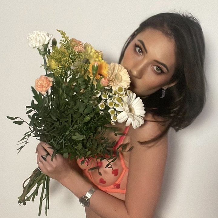 Alice looking over a bouquet of flowers